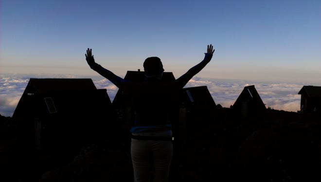 Nancy Loughlin enjoys an early morning above the clouds at Horombo Huts, 12,000 feet up Mt. Kilimanjaro.