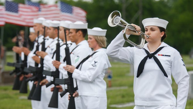 A member of the United States Navy Honor Guard plays "Taps" during the funeral service for Clifford George Goodwin at the Diamond Cemetery on Saturday, May 12, 2018. Goodwin was killed at Pearl Harbor during World War II while serving aboard the USS Oklahoma with the U.S. Navy. His remains were recently identified using DNA analysis and he was returned to Missouri from Hawaii to be buried with full military honors.