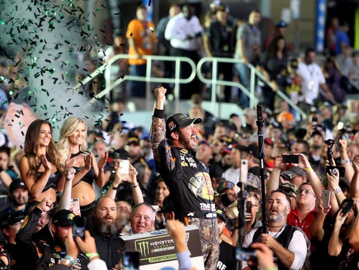 Martin Truex Jr. (78) celebrates winning the NASCAR