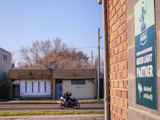 A motorcycle drives past the scene where a homicide occurred outside an after hours bar on Detroit's east side at Westphalia and East 7 Mile earlier this year on Thursday, April 19, 2018, across the street from a laundry mat that is a Green Light Partner with the City of Detroit.