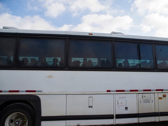 Buses carrying people leave the Border Patrol processing