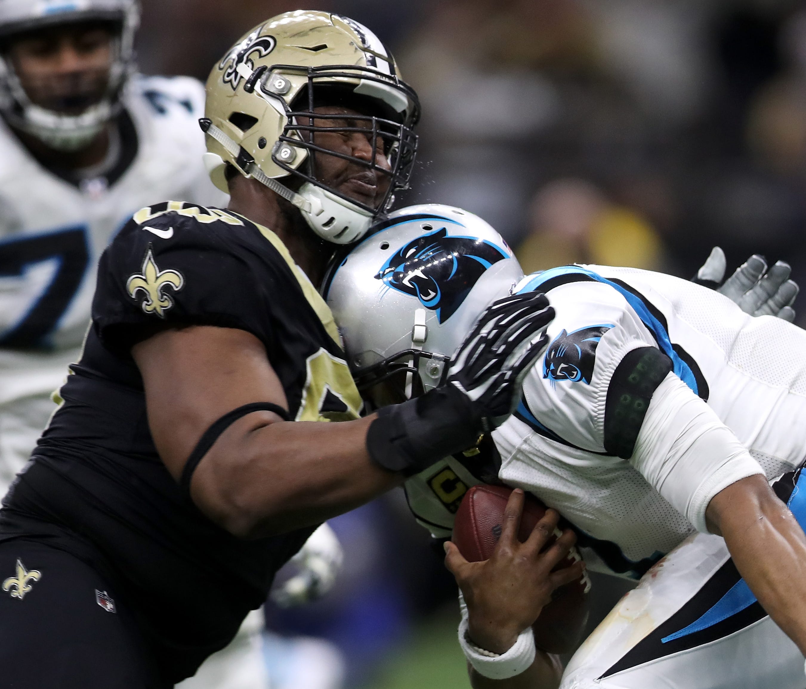 Saints DL David Onyemata crashes into Panthers QB Cam Newton, right, in Sunday's wild-card game.
