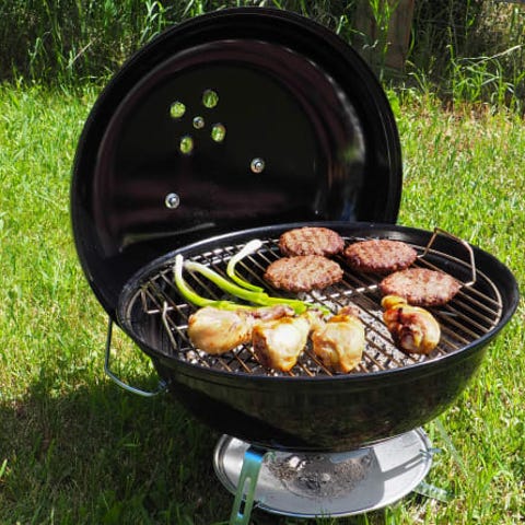 Black portable grill in the grass