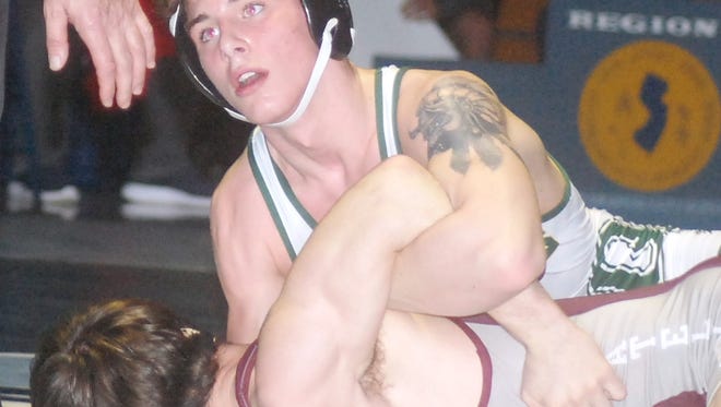 Queen of Peace junior Garrett Beam looking up as he holds down Brian Meyer of Phillipsburg in the Region 3 145-pound final.