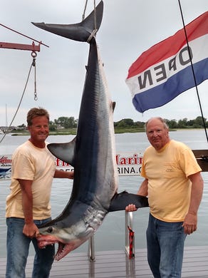 Bob Thomas (left), Manasquan, and Joe Loverde, Manalapan, caught this 315-pound mako shark on June 25. It took a little over an hour and a half to land the fish, which was weighed in at Hoffman?s in Brielle.