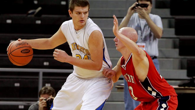 NewCath's Drew McDonald is defended by St. Henry's Jordan Noble in March.