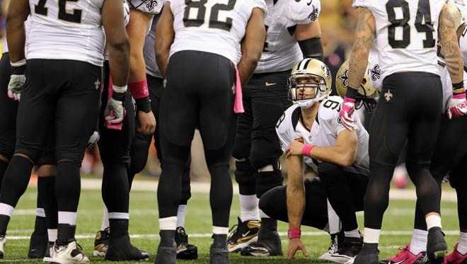 Oct 5, 2014: New Orleans Saints quarterback Drew Brees (9) calls a play in their huddle during overtime of their game against the Tampa Bay Buccaneers at the Mercedes-Benz Superdome. The Saints won in overtime, 37-31.