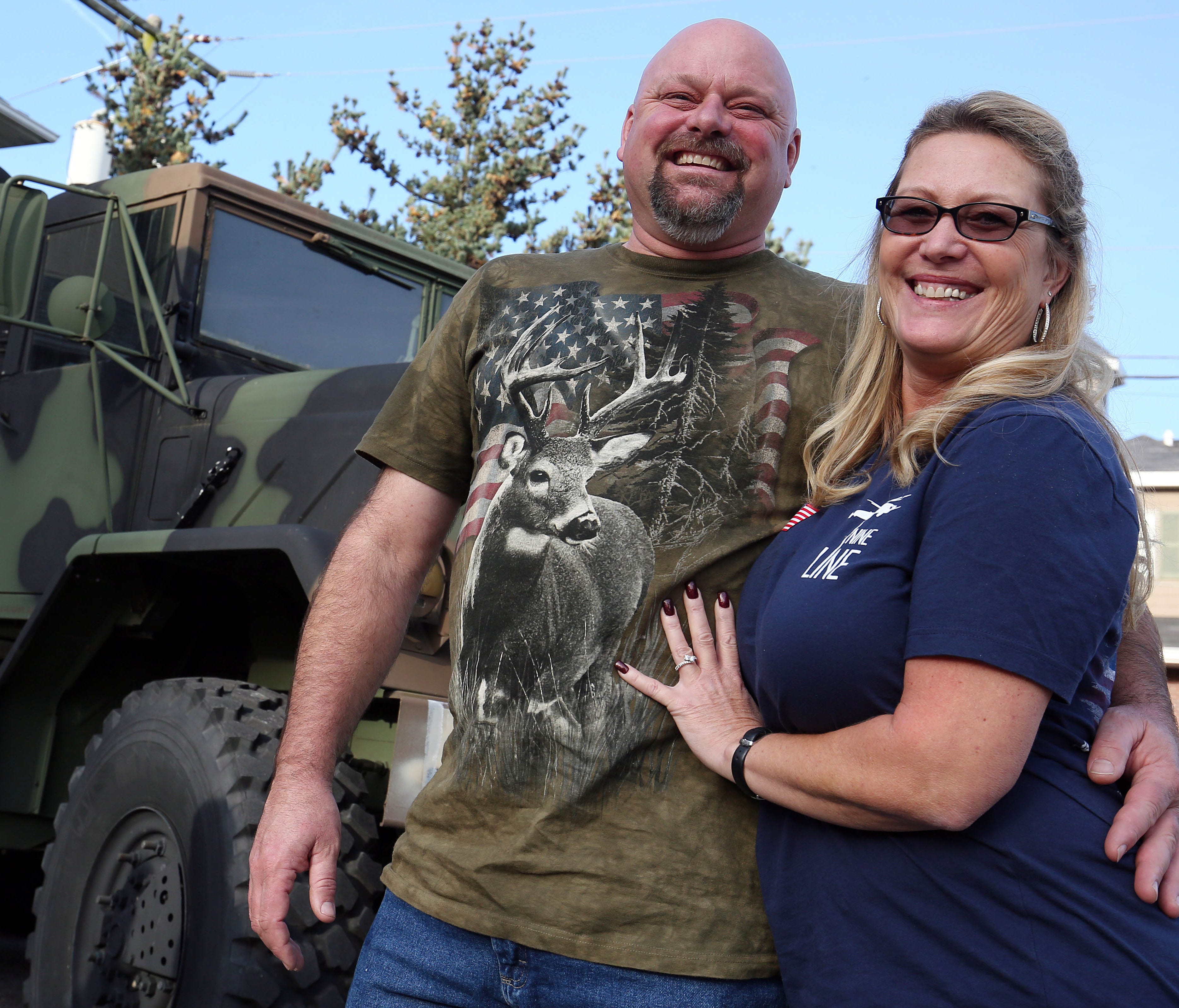 Jack McLain and Jorja Moore of Howell pose with their surplus US Army truck in front of Woody's. Woody's Tavern in Farmingdale didn't show football on Sunday in respect for veterans on Veterans Day weekend. In place of the games, the bar will hold a 