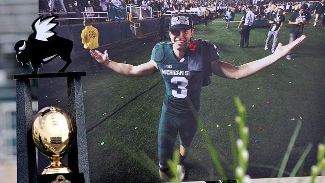 A giant photo of Mike Sadler is on display at his memorial at Spartan Stadium Sunday, July 31, 2016. The star punter was killed in a car crash July 23rd.