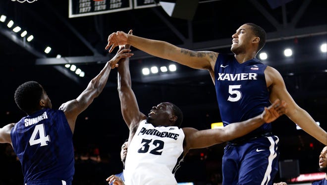 Providence Friars guard Junior Lomomba (32) shoots the ball against Xavier Musketeers guard Edmond Sumner (4) and guard Trevon Bluiett during the first half at Dunkin Donuts Center.