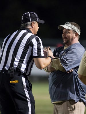 Milton head coach Harry Lees has a chat with a referee during the Gulf Breeze vs Milton high school football game in Milton on Friday, September 29, 2017.