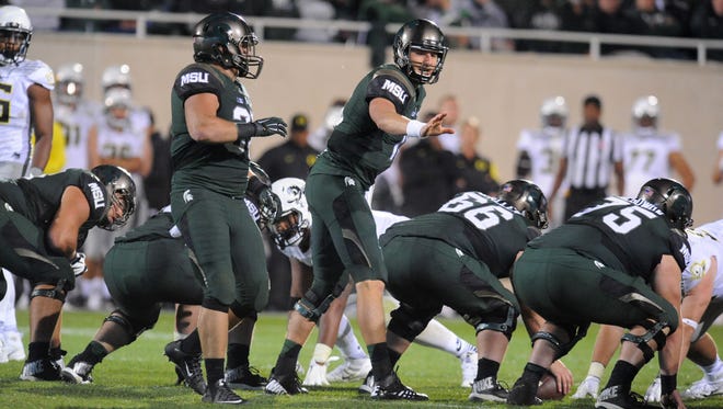 MSU's Connor Cook directs the offense o the key late drive against Oregon Saturday at Spartan Stadium.