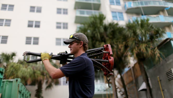 Aaron Goode, 19, works on a job site after recently being hired by Southeastern Chiller Services on July 2, 2014 in Sunny Isles, Fla. The U.S. Labor Department said Aug. 18 that unemployment rates ticked up in 30 states in July.