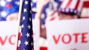 Stock image of an American political rally with vote signs.