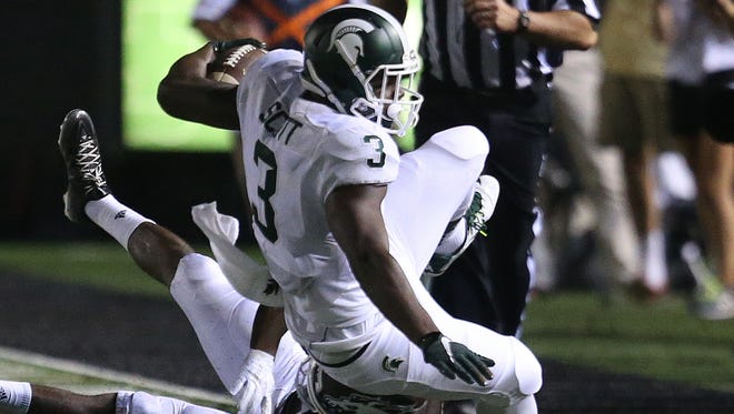 Michigan State running back LJ Scott is tackled during the second half Friday in Kalamazoo.