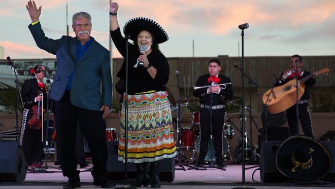 Roberto Estrada, left, and Executive Director of Cancer Aid Resource and Education (CARE) of Southern New Mexico Yoli Rigales Diaz cheer to the crowd, September 23, 2016, after announcing the Roberto’s Enchilada Tasting Contest to be held on Sunday, September 25, 2016, at noon in part of The Big Event festivities.