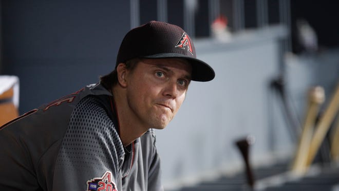 Arizona Diamondbacks starting pitcher Zack Greinke watches from the dugout during the third inning of a baseball game against the Los Angeles Dodgers, Friday, April 13, 2018, in Los Angeles. (AP Photo/Jae C. Hong)