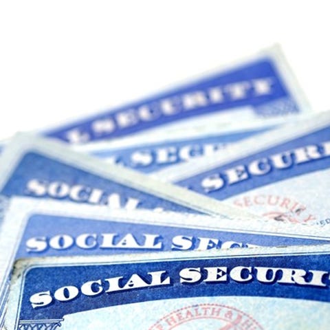 A small, messy stack of Social Security cards.