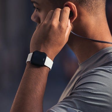 Man in workout gear wearing a Fitbit Versa Smartwatch