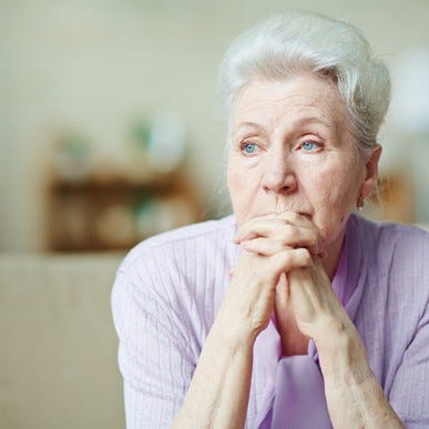 Older woman looking worried with her hands crossed