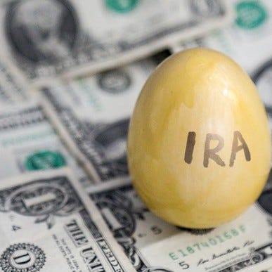 Golden egg with IRA written on it on top of $1 bills