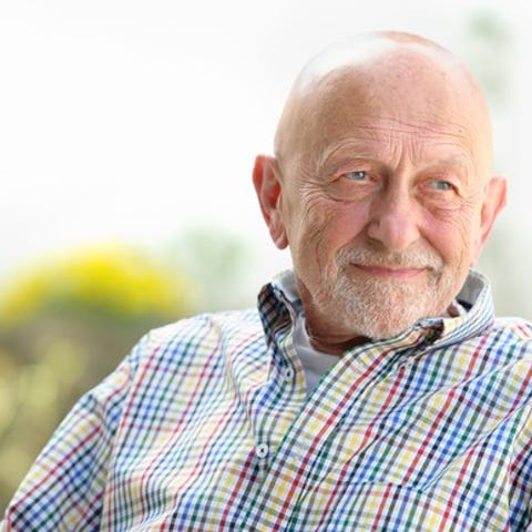 Smiling older man outdoors.