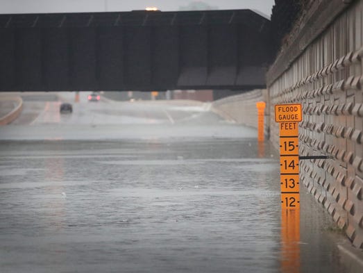 A gauge shows the depth of water at an underpass on