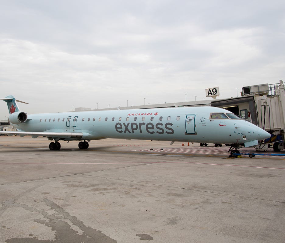 An Air Canada Express Bombardier CRJ-700 rests at the gate at George Bush Houston Intercontinental Airport in June 2015.