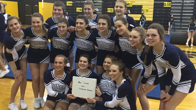 The Marysville cheer team poses after winning their second MAC Silver title in a row.