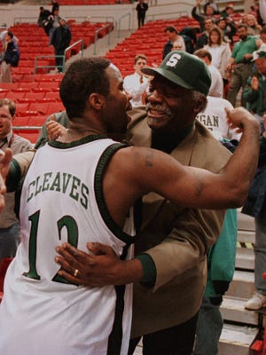 Mateen Cleaves gets a hug from his father, Herbert Cleaves, on March 14, 1998.
