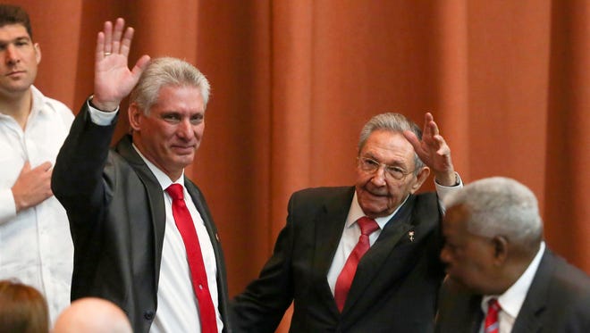 Cuba's new president Miguel Diaz-Canel, left, and former president Raul Castro, salutes, after Diaz-Canel was elected as the island nation's new president.