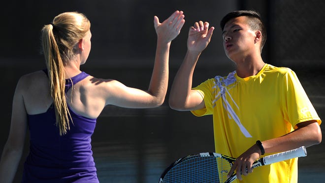 Wylie's Spencer Lin (right) celebrates a point with partner Ashley Smyser  during the mixed doubles championship against teammates Zane McCurley and Andrea McMillan in the District 5-4A tennis tournament on Thursday, April 6, 2017, at Hardin-Simmons University's Streich Tennis Center.