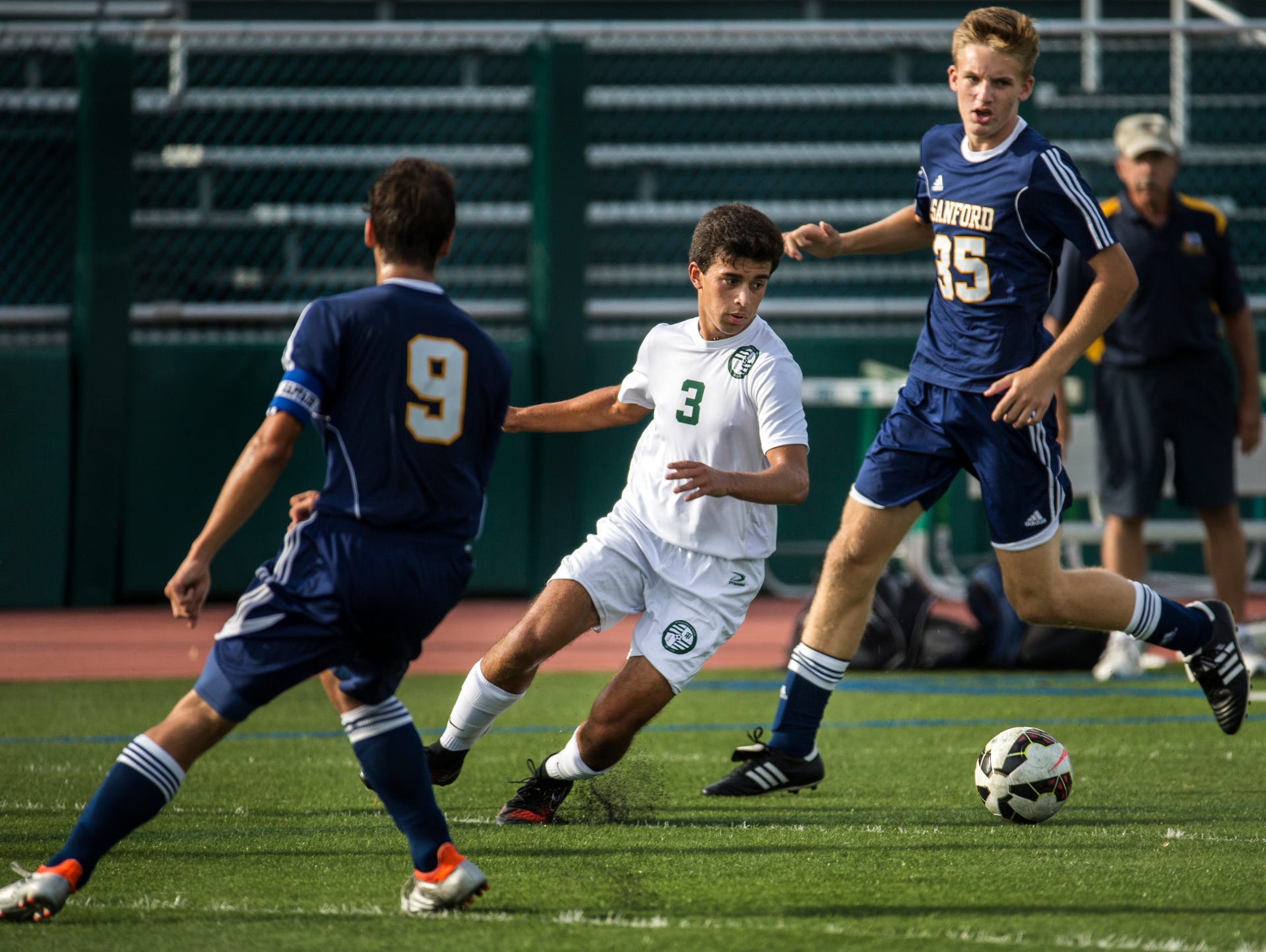 Tower Hill's Andrew Cercena (No. 3) cuts between Sanford's James Vernon (No. 9) and Jordan West (No. 15) in the first half of Tower Hill's 3-1 win over Sanford at Tower Hill School in Wilmington on Wednesday afternoon.