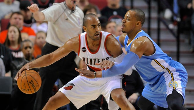 Denver Nuggets' Randy Foye, right, defends against Portland Trail Blazers' Arron Afflalo, left, during the first half of an NBA basketball game in Portland, Ore., Saturday, March 28, 2015.