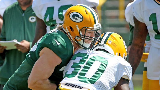 Green Bay Packers outside linebacker Clay Matthews (52) tries to take the ball from running back Jamaal Williams (30) during training camp Monday, August 7, 2017, at Ray Nitschke Field.