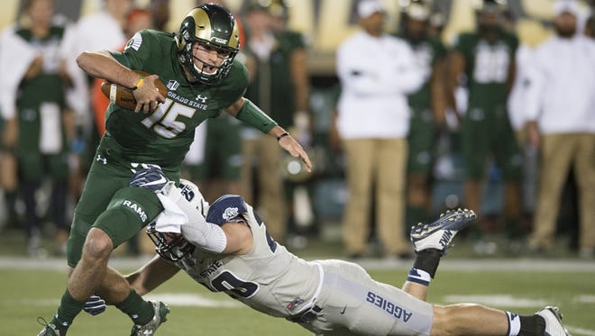 CSU quarterback Collin Hill is sacked by Utah State linebacker Brock Carmen at Hughes Stadium on Saturday. Hill tore his ACL on a non-contact play later in the game.