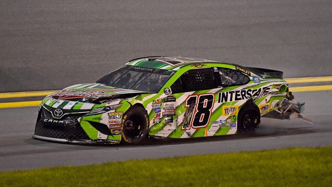 NASCAR Cup Series driver Kyle Busch (18) takes his wrecked car to the pits during the Coke Zero 400 Powered by Coca-Cola at Daytona International Speedway.