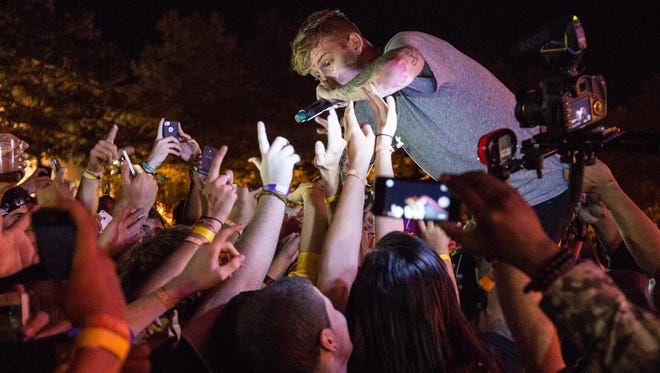Machine Gun Kelly headlined the Foxtail Fest in Wilmington. The concert’s organizers have filed suit against the city over a $6,800 tab for police security at the event.
