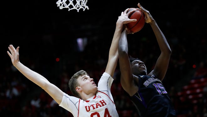 Utah forward Jayce Johnson, left, goes for the block against Washington's Noah Dickerson in the first half Saturday.