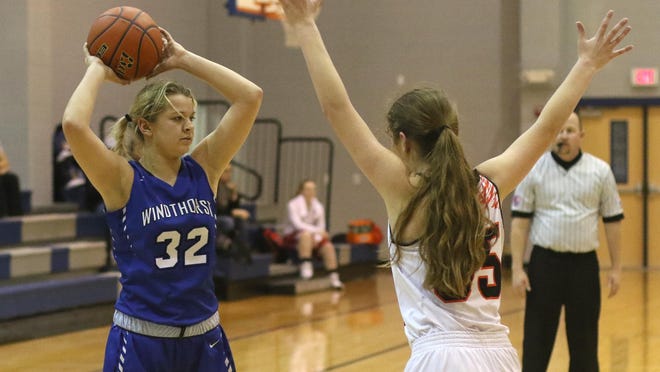 Windthorst's Tatum Veitenheimer looks to pass while guarded by Springtown's Hanna Turman in the Windthorst Tournament Tuesday, Dec. 27, 2016, in Windthorst.