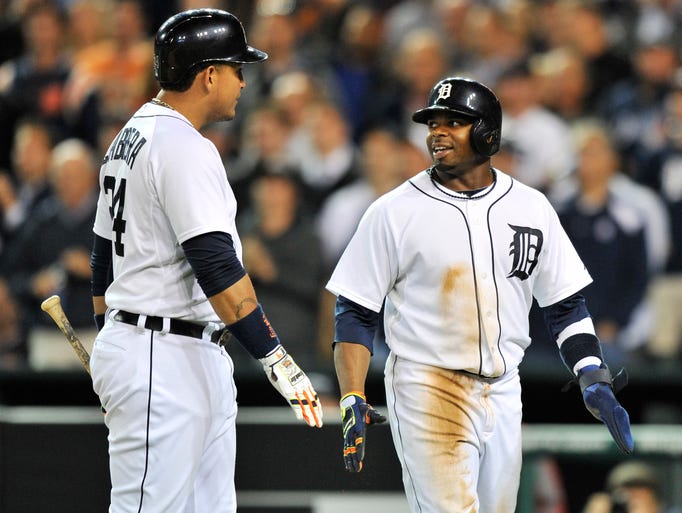 Tigers' Miguel Cabrera talks with Rajai Davis, right, after Davis scores on a ground rule double by Torii Hunter in the seventh inning.
