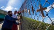 Dustin Singh, left, and Jason Price hang flowers alongside