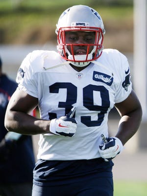 The New England Patriots' newly acquired running back Montee Ball (39) jogs during a stretching session before practice begins at the NFL football team's facility Wednesday in Foxborough, Mass.