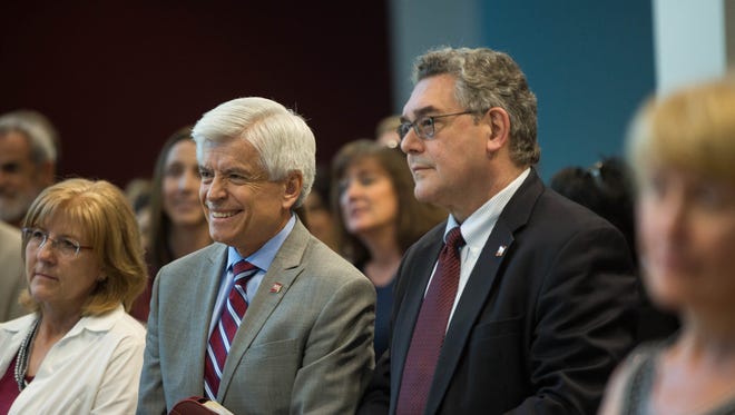 Dan Arvizu, left, New Mexico State University's chancellor designate, and President-designate John Floros, right, listen to Debra Hicks, the chair of the NMSU Board of Regents, at a meet-and-greet Tuesday, May 22, 2018, at Corbett Center on the NMSU campus.