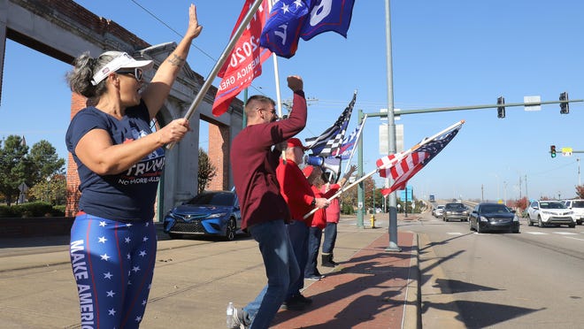 A small group of enthusiastic President Donald Trump supporters rally at the corner of Garrison Ave. and S 3rd Street, Saturday, Nov. 7, to show their support.