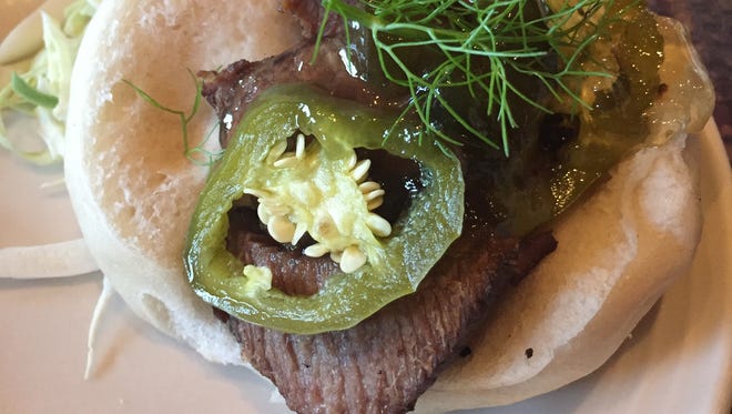 Odds and ends bar bites at Braise, 1101 S. 2nd St., are served at modest prices during happy hour Tuesday to Thursday. The menu changes; previously, it included this braised brisket on a steamed bun with pickled jalapeno for $4.