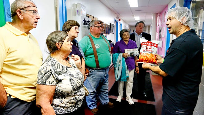 Rick Mong, right, of Martin's Potato Chips, talks about how potatoes are packaged during a tour of the factory in Thomasville, in this June 15, 2016, photo. The snack food maker will be hosting York County high schoolers next week as part of the second annual Manufacturing Days. Dawn J. Sagert photo