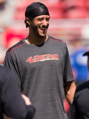 49ers quarterback Colin Kaepernick watches warmups out of uniform before the Aug. 16 game against the Houston Texans.