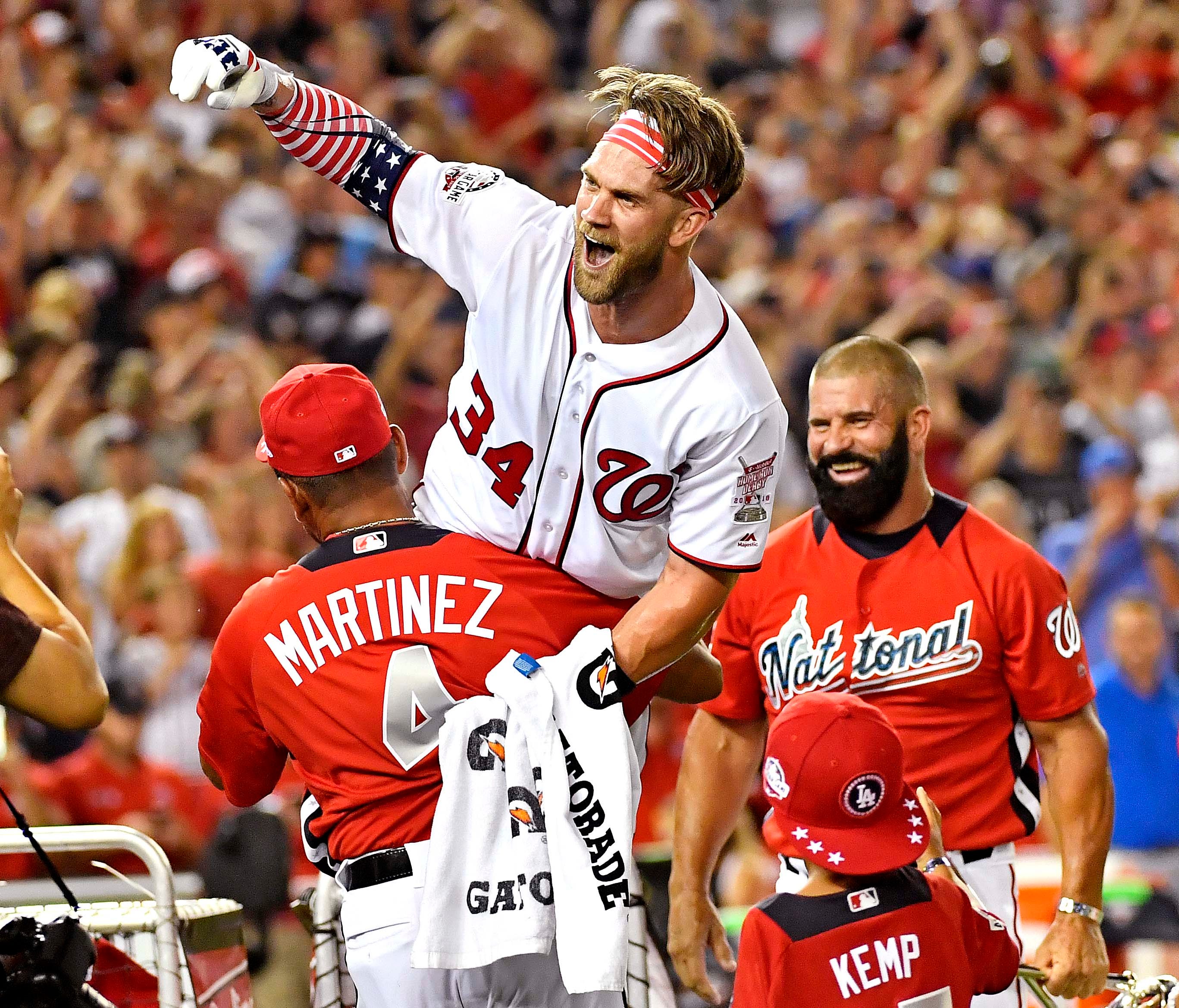 Bryce Harper celebrates with manager Dave Martinez after winning the Home Run Derby.