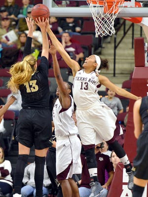 Texas A&M guard Chelsea Jennings, right, blocks a shot attempt by Vanderbilt's Audrey-Ann Caron-Goudreau during the first half of an NCAA college basketball game Friday, Jan. 2, 2015, in College Station, Texas. (AP Photo/Bryan-College Station Eagle, Sam Craft)